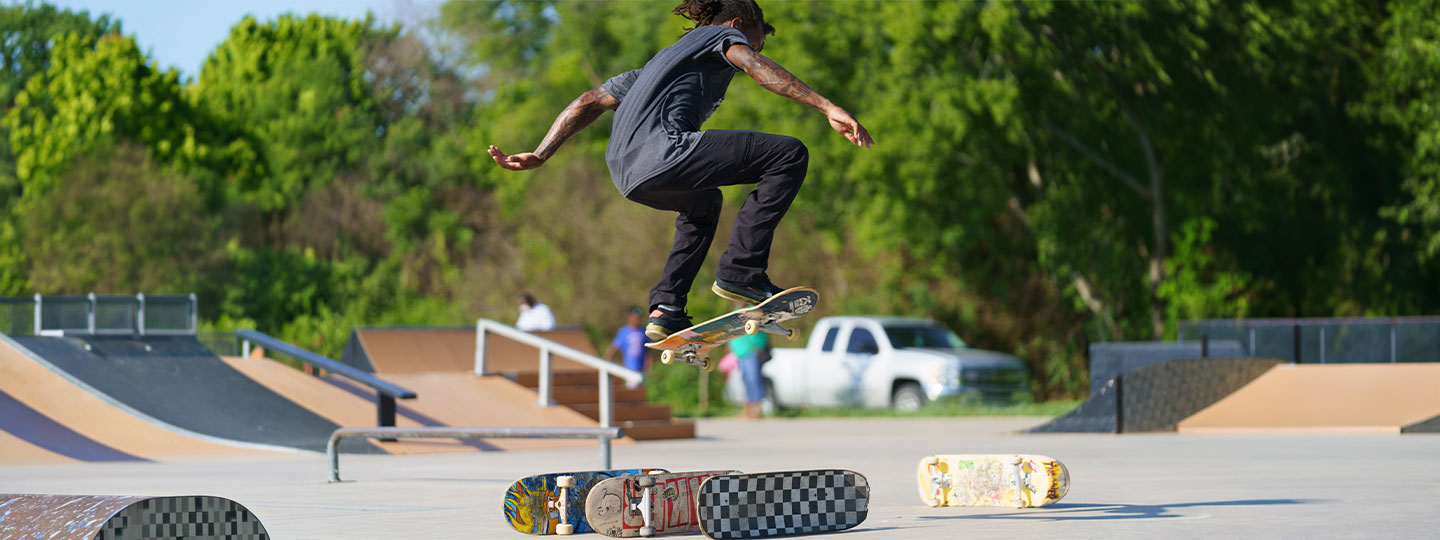 temple skateboarder jumping other boards